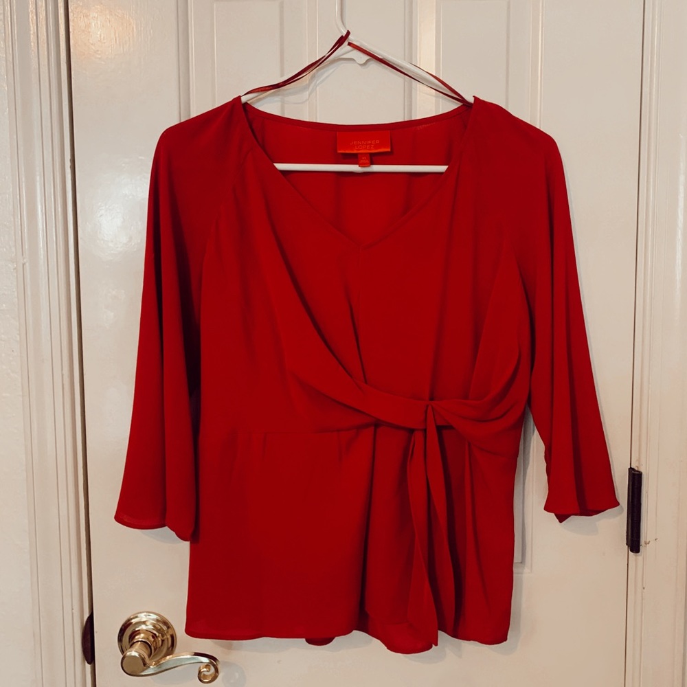 Red V-neck blouse with quarter length sleeves and front left tie detail